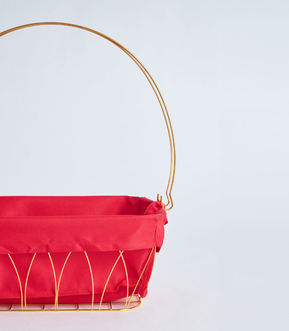 Luxury gold metal wire basket with red fabric lining and arched handle for premium gift presentation