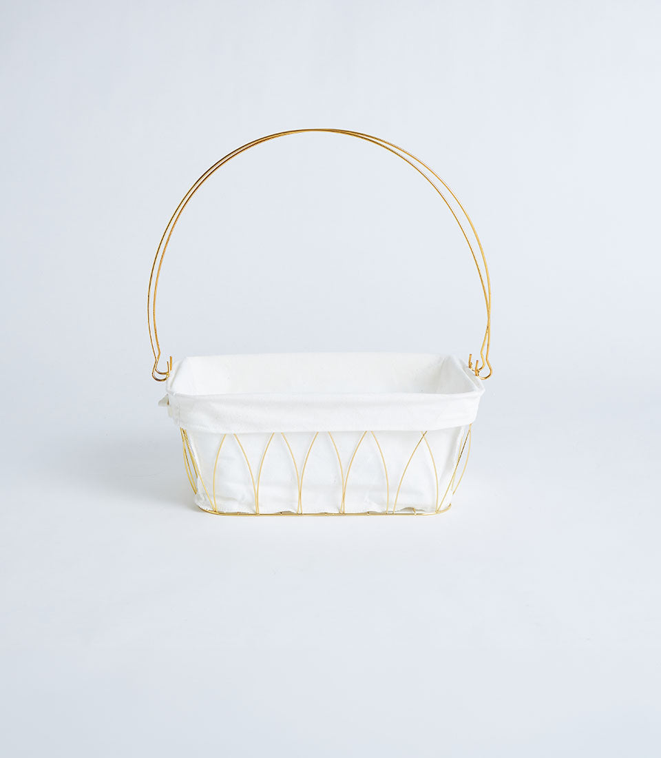 Gold metal wire basket with white fabric lining and arched handle