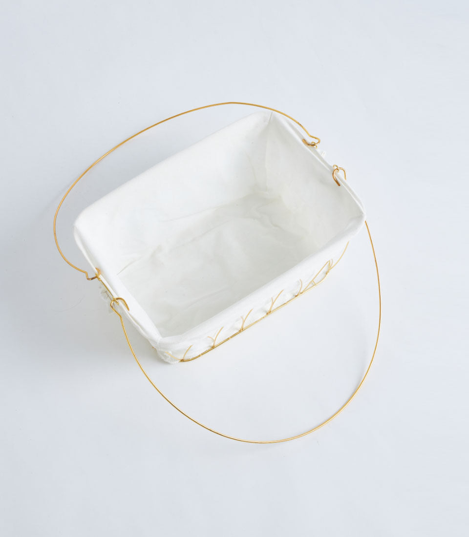 Gold wire openwork rectangular basket with white fabric lining and elegant handle