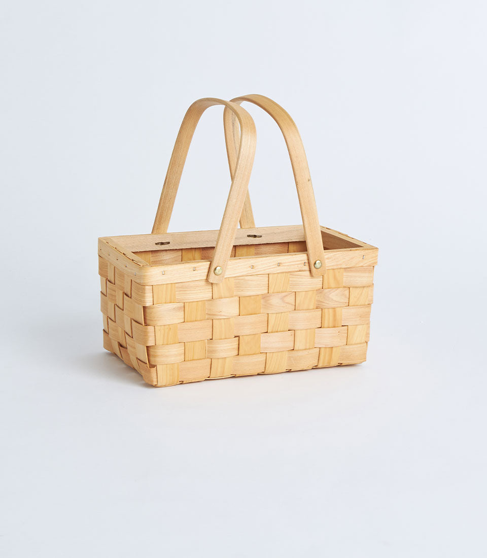 Natural woven bamboo rectangular basket with dual wood handles for curated gift hampers