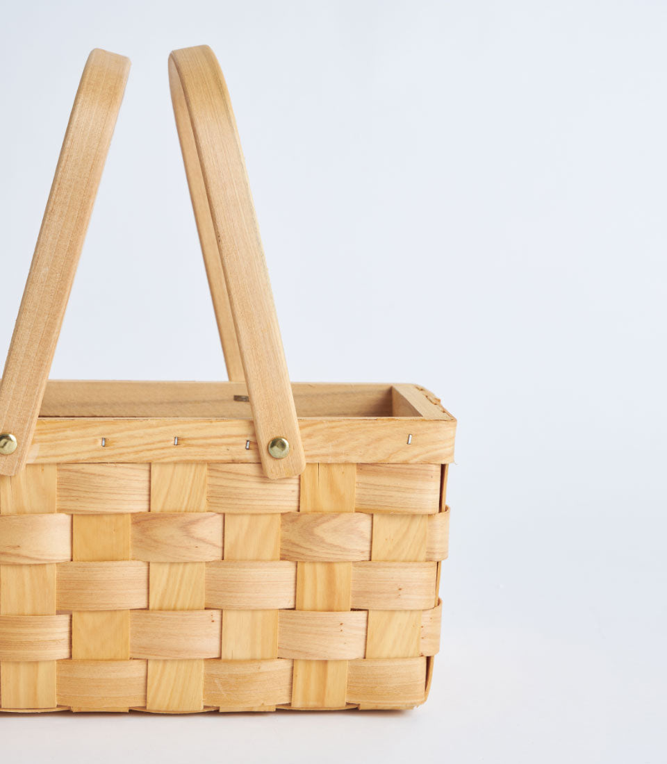 Light woven bamboo basket with arched double handles for premium gifting