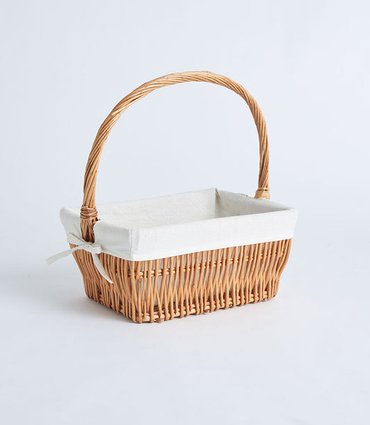 Natural wicker rectangular basket with cream linen lining and arched handle