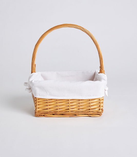 Light brown woven rattan rectangular basket with white fabric liner and tall arched handle