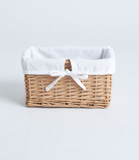 Natural wicker rectangular basket with white fabric lining and ribbon bow