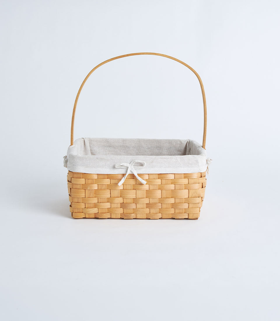 Natural woven wooden basket with arched handle and fabric linen liner