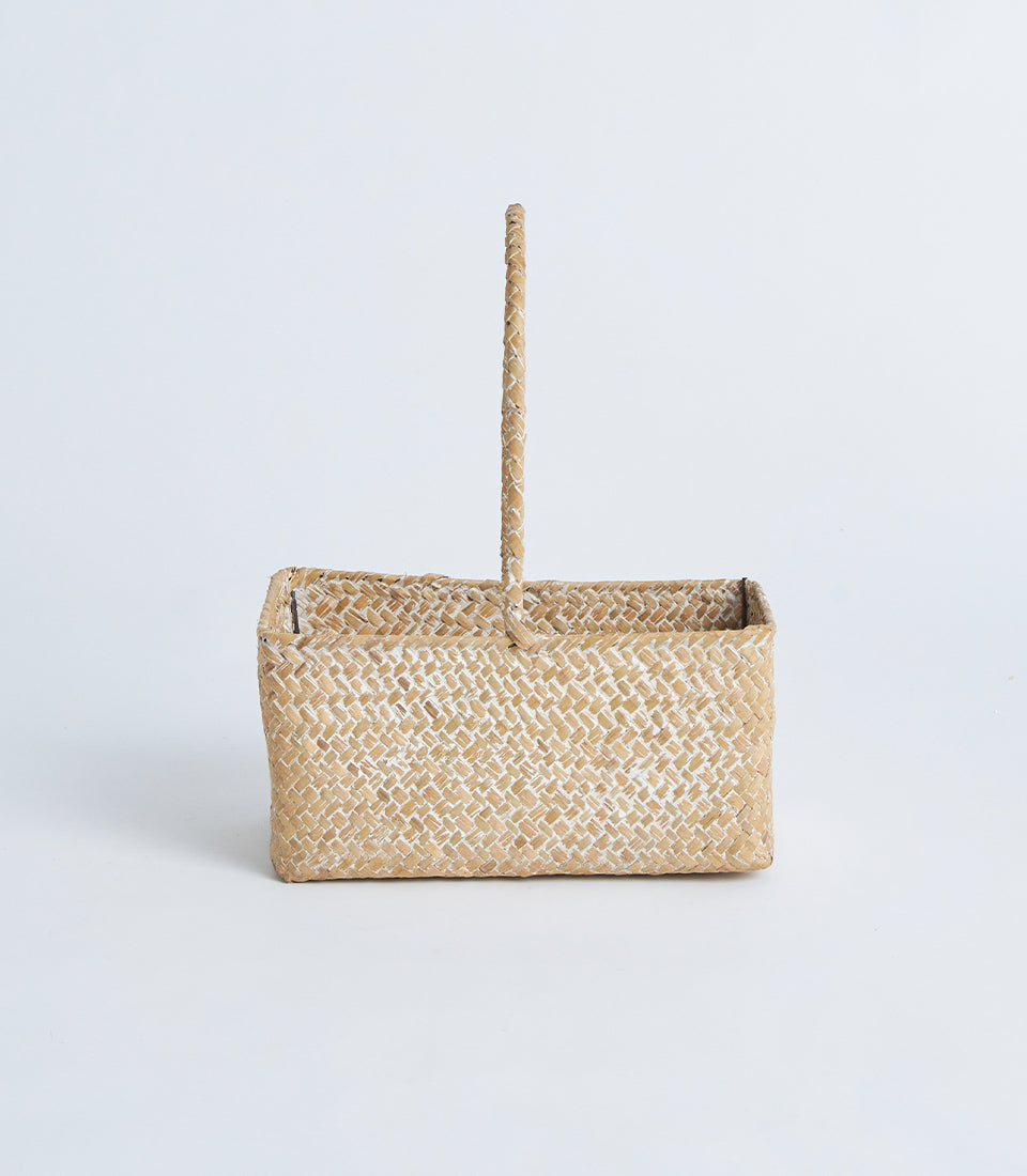 Light natural woven rectangular basket with braided handle for artisan gift presentations