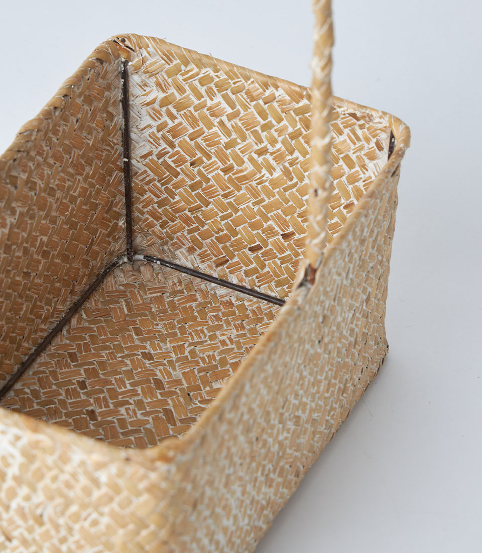Light natural woven rectangular basket with braided handle, whitewashed seagrass construction