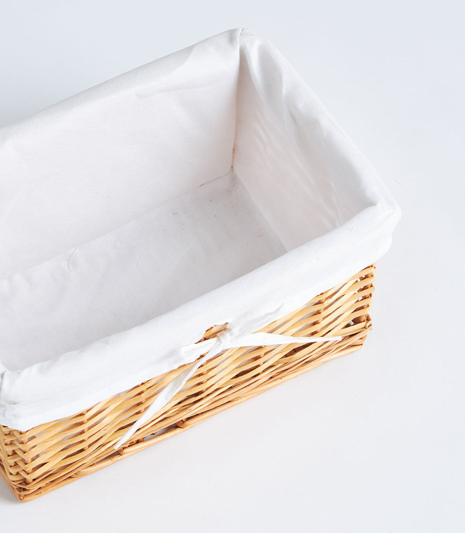 Basketeer's handwoven rectangular wicker basket, lined with pristine white linen