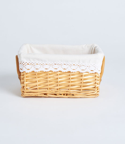 Handwoven rectangular wicker basket with cream lace-trim fabric lining and natural rustic weave