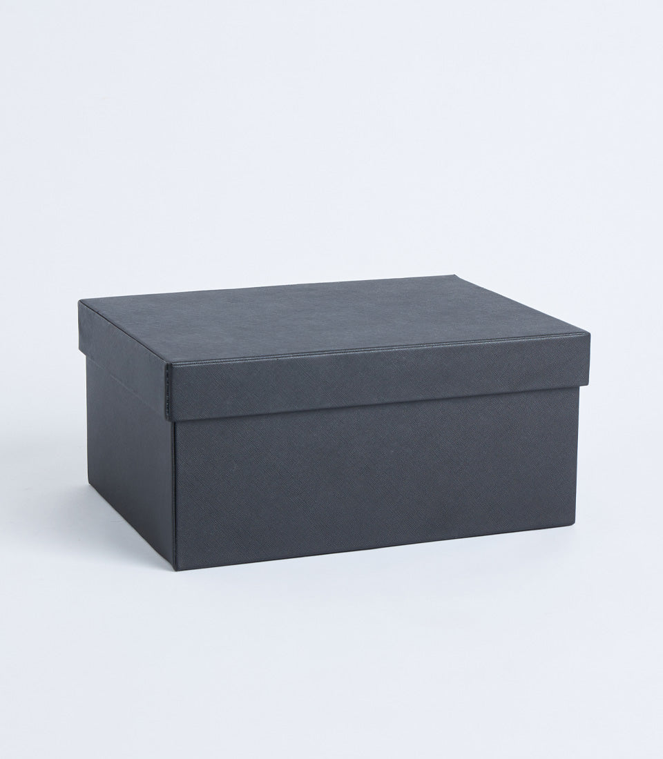 Black leather storage box with refined crosshatch texture and fitted lid for luxury gifting