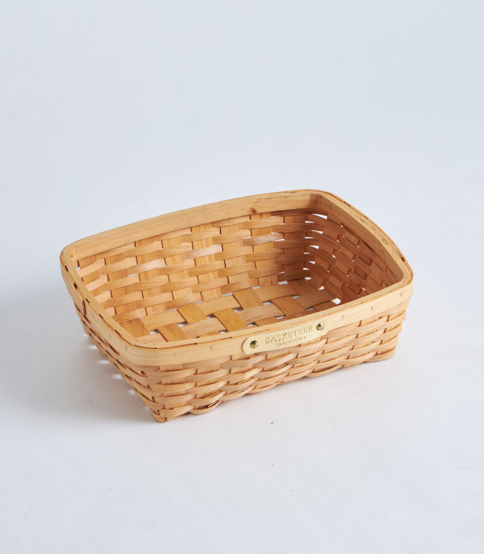Handwoven natural bamboo oval tray basket with metal tag detail