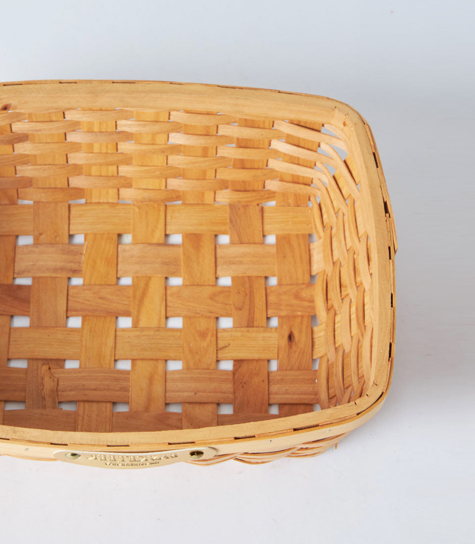 Natural woven bamboo oval tray basket with light wood finish and metal rim detail