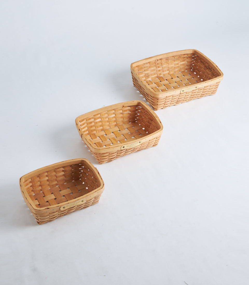 Natural woven bamboo oval baskets in light wood tones, handcrafted storage in three graduating sizes