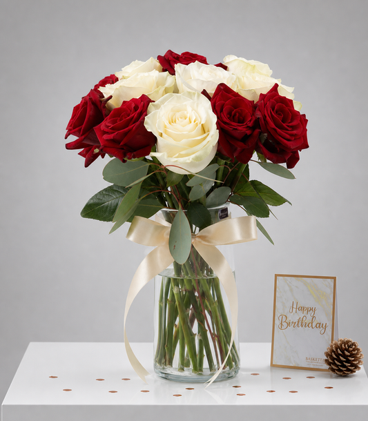 Elegant vase arrangement of premium red and white roses with fresh eucalyptus, tied with