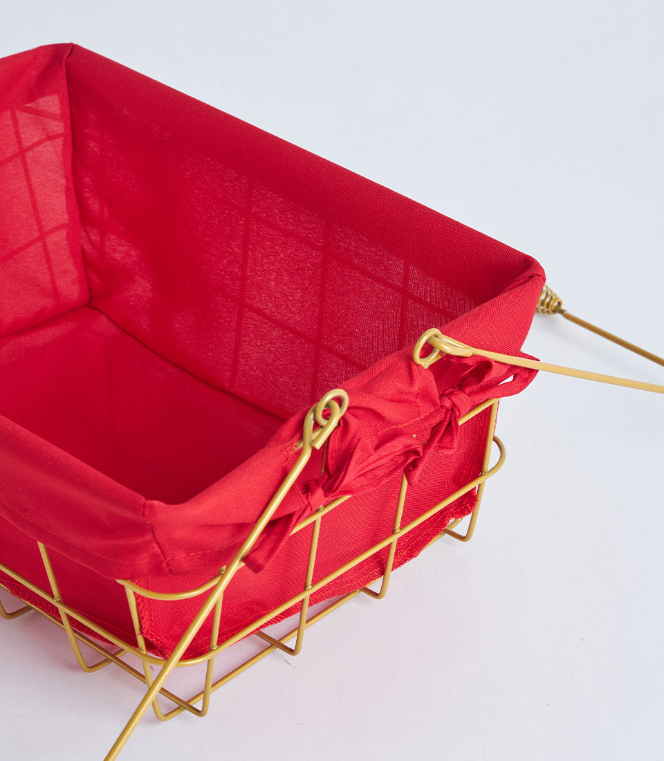 Gold wire basket with red fabric lining and metal handles for luxury gift presentation