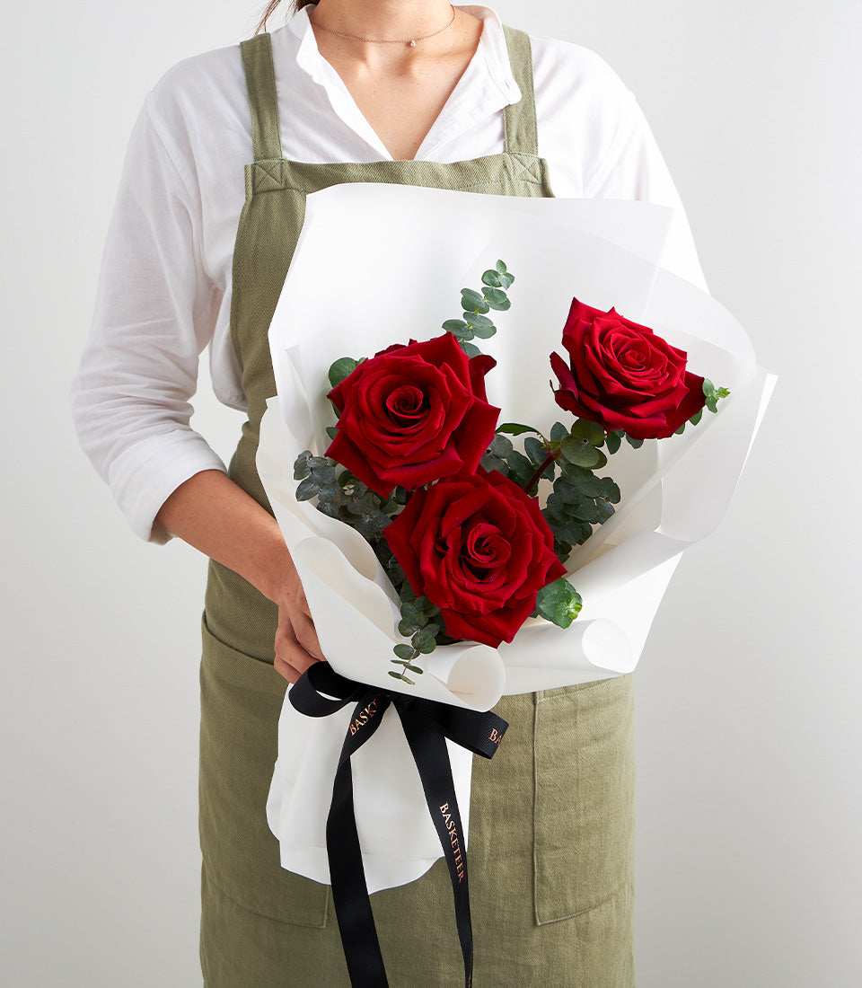 A luxurious rose bouquet from Flowers by Basketeer featuring three vibrant red roses and