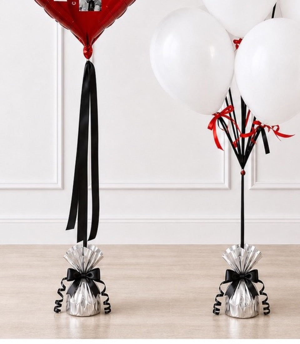 Elegant balloon weights featuring silver metallic bases with black bows, black ribbons, and red and white balloons in modern minimalist style.