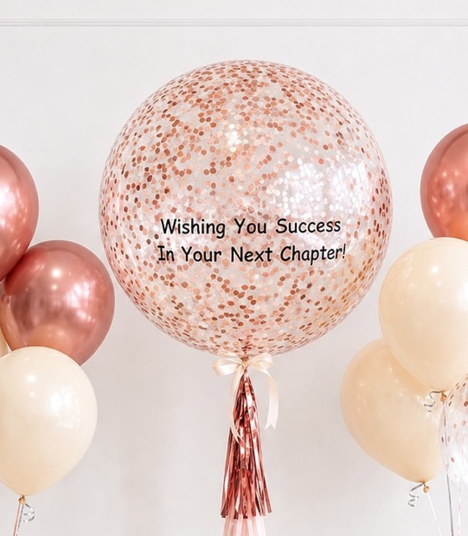 Rose gold confetti-filled balloon with cream and metallic pink balloons, featuring "Wishing You Success In Your Next Chapter" text.