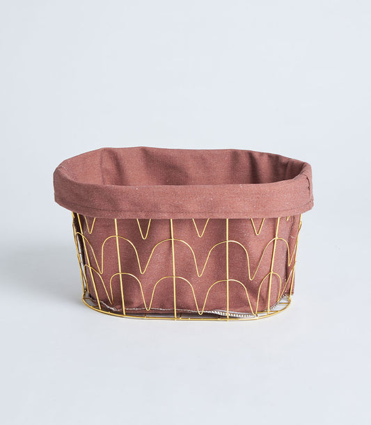 Gold metal frame storage basket with dusty rose linen lining and tall handles