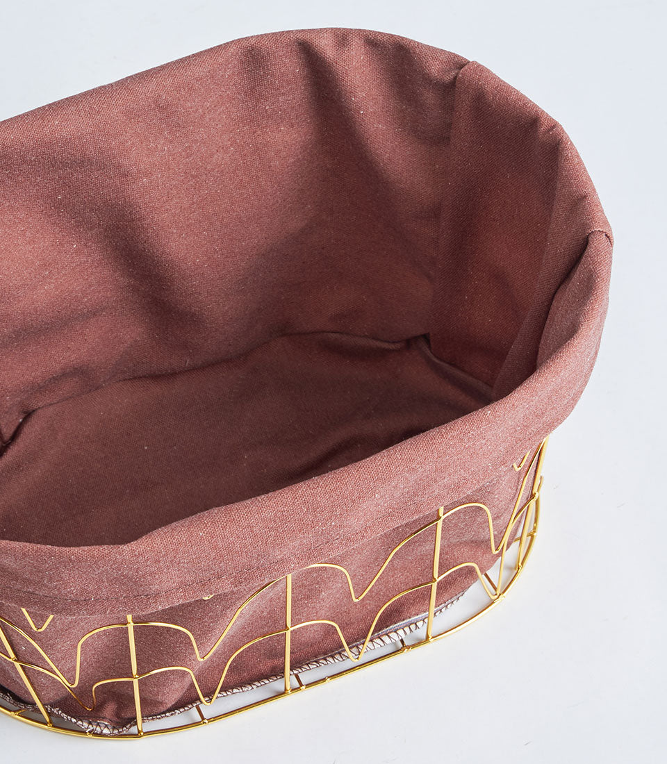 Oval metal wire basket with burgundy fabric lining and tall gold handles