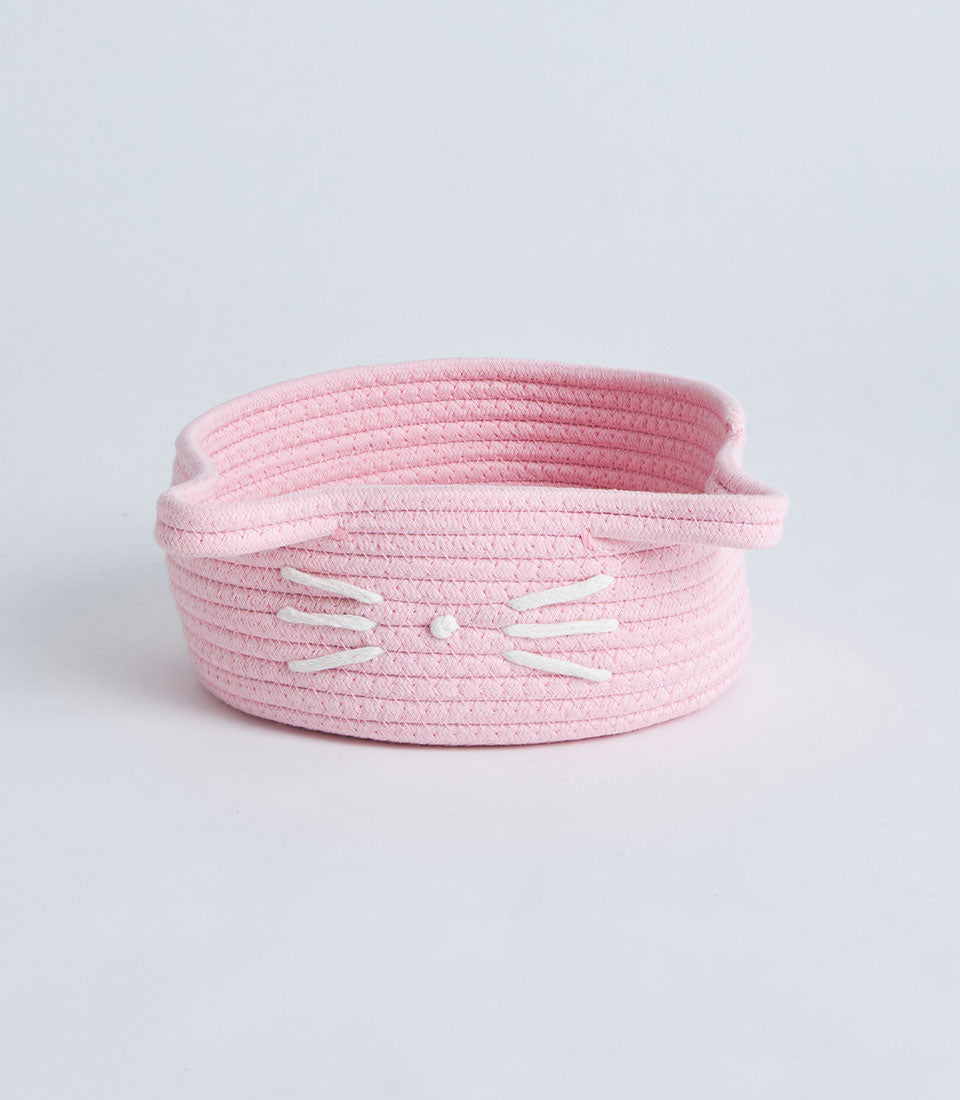 Pink woven rope storage basket with cat face design and embroidered whiskers