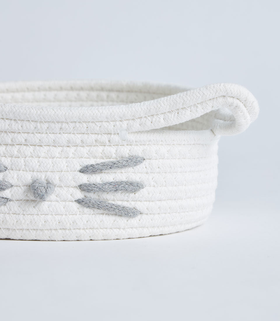 White cotton rope storage basket with cat face design and handles