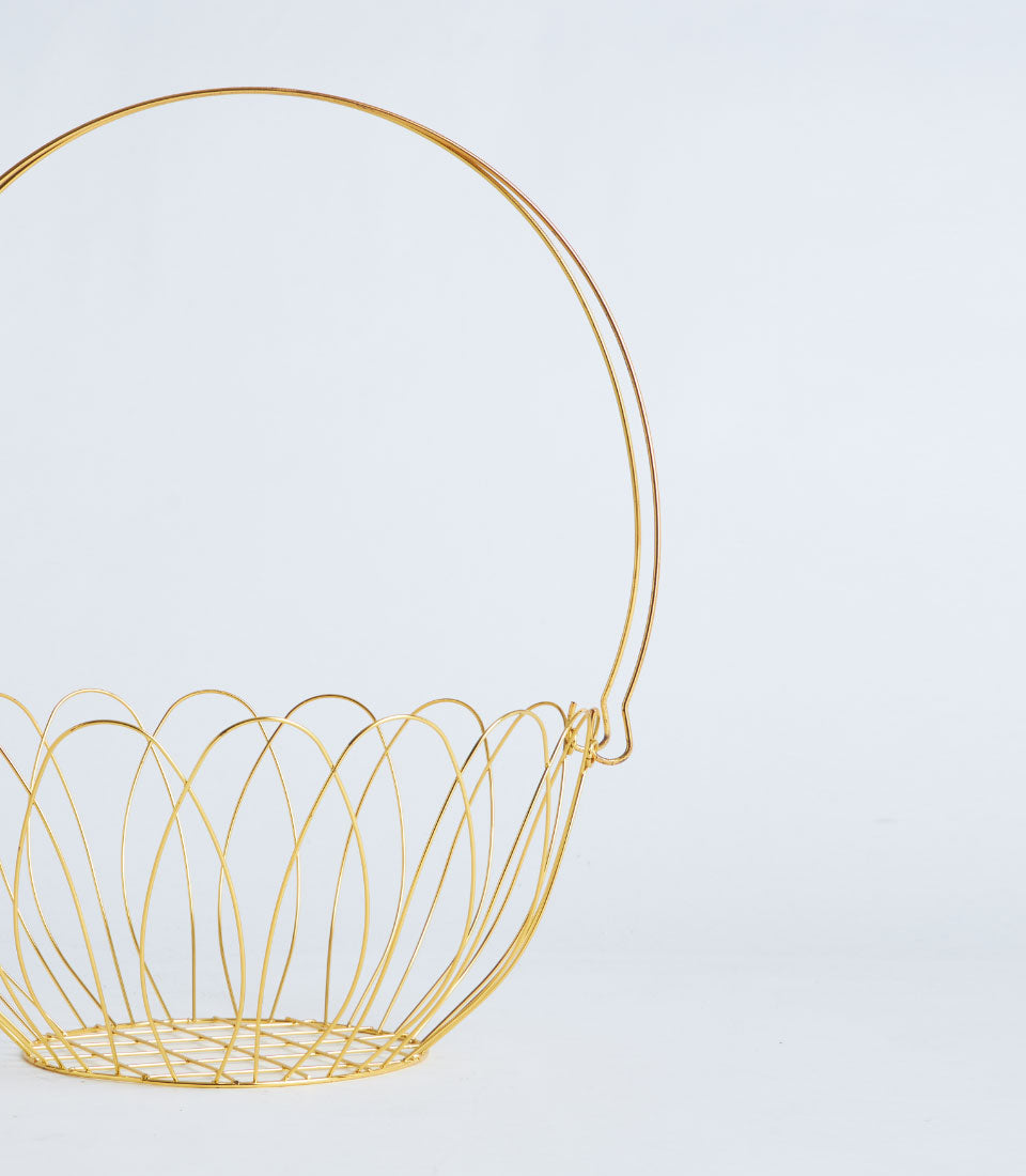 Gold wire basket with handle, minimalist metal design for luxury gift presentation