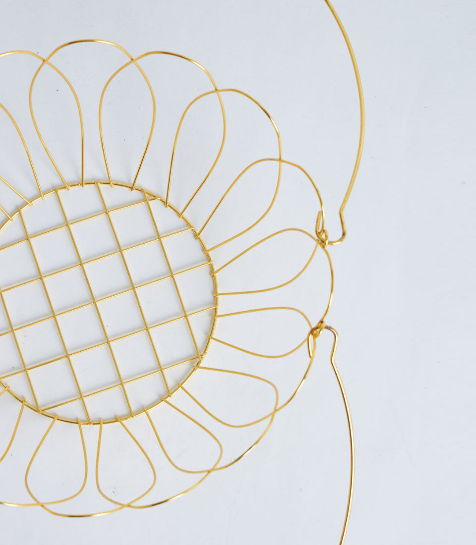 Gold metal wire basket with floral petal design and dual handles for luxury gifting