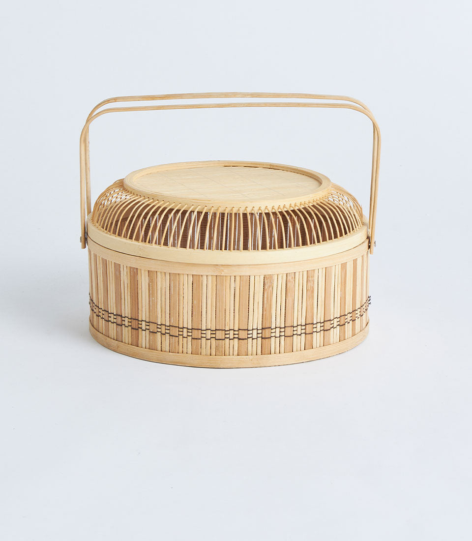 Natural bamboo round basket with woven lid and arched handle for premium gift hampers