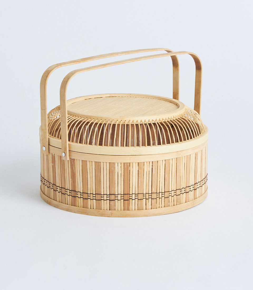 Natural bamboo round basket with dome lid and curved handles, light wood finish