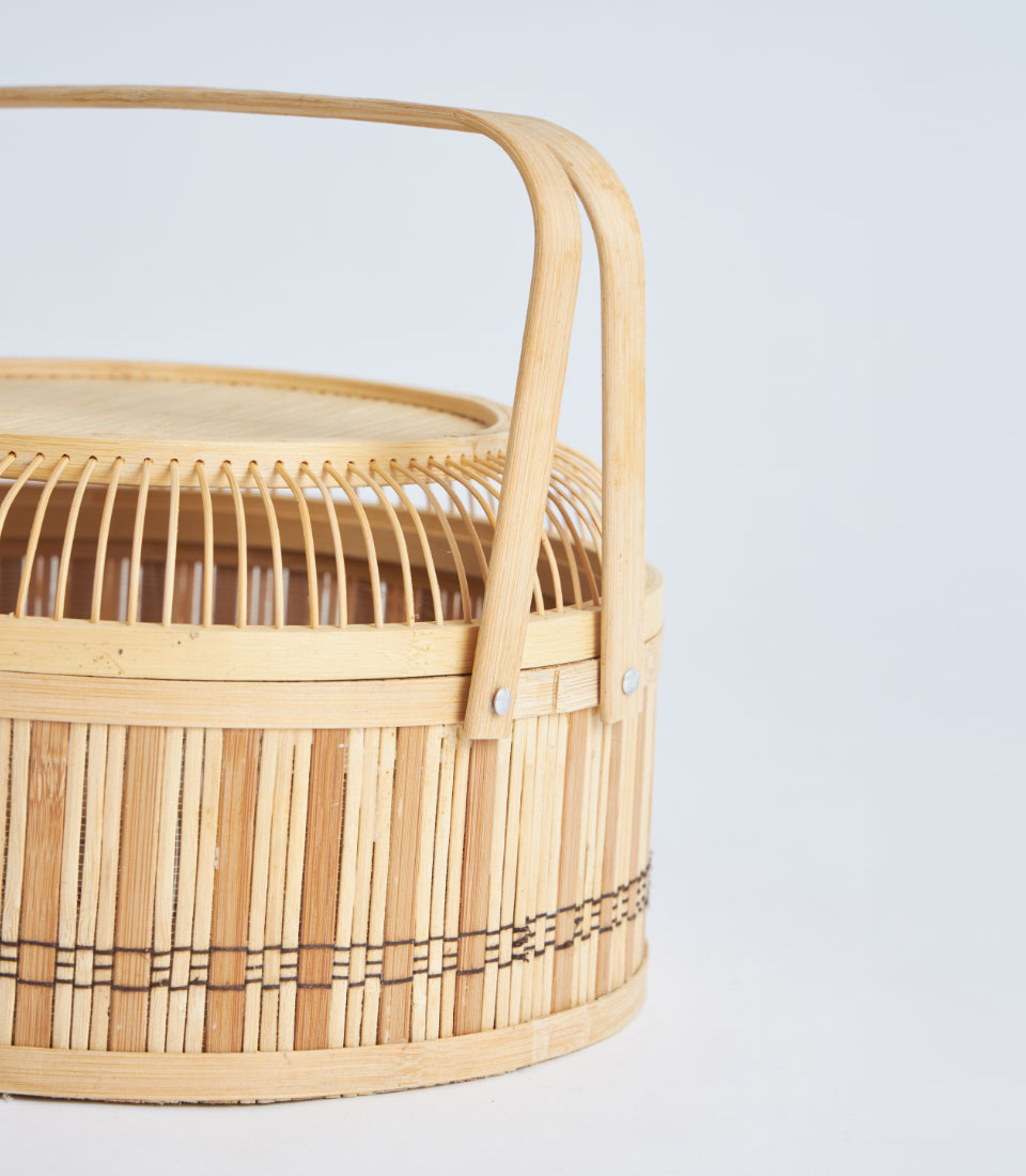 Natural bamboo round basket with woven lid and handle for elegant gift storage