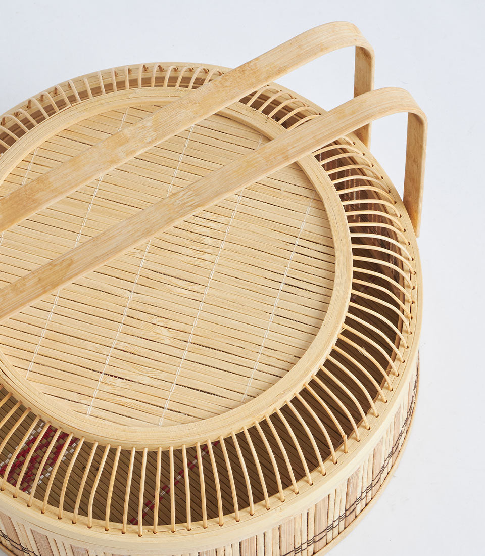 Natural bamboo round basket with lid and dual handles for artisan gift presentation