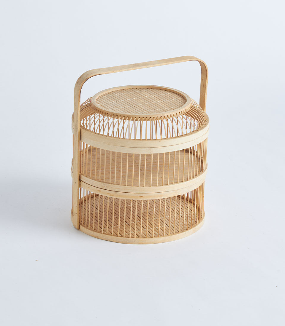 Natural bamboo tiered food carrier with woven handle, handcrafted for artisan gifting