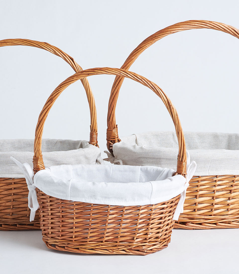Handwoven natural wicker baskets with fabric liners and ribbon, ready for gift presentation