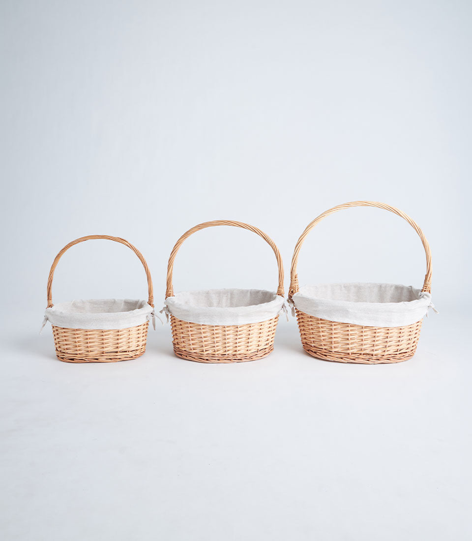 Natural wicker gift baskets with fabric liners in three sizes, ready for luxury gifting