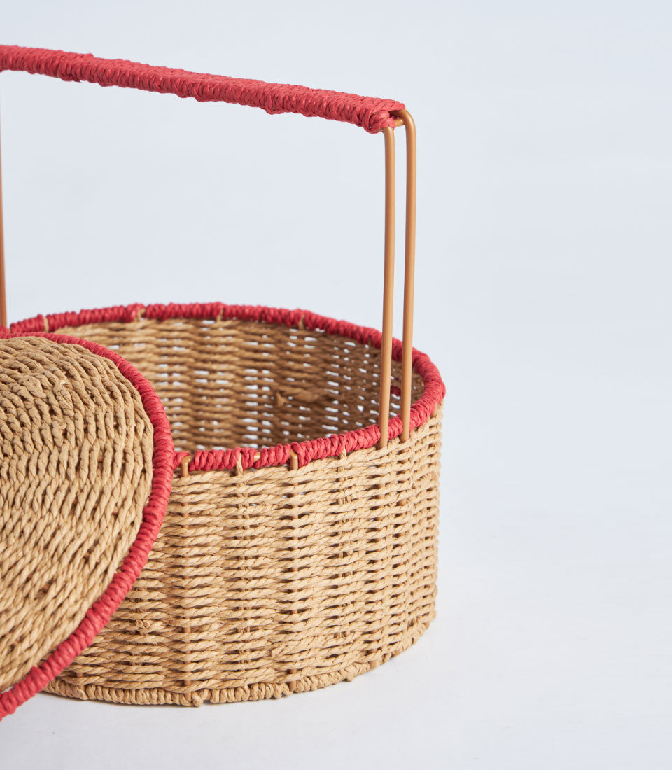Natural woven basket with red trim handle and lid, ready for luxury gift hamper packing