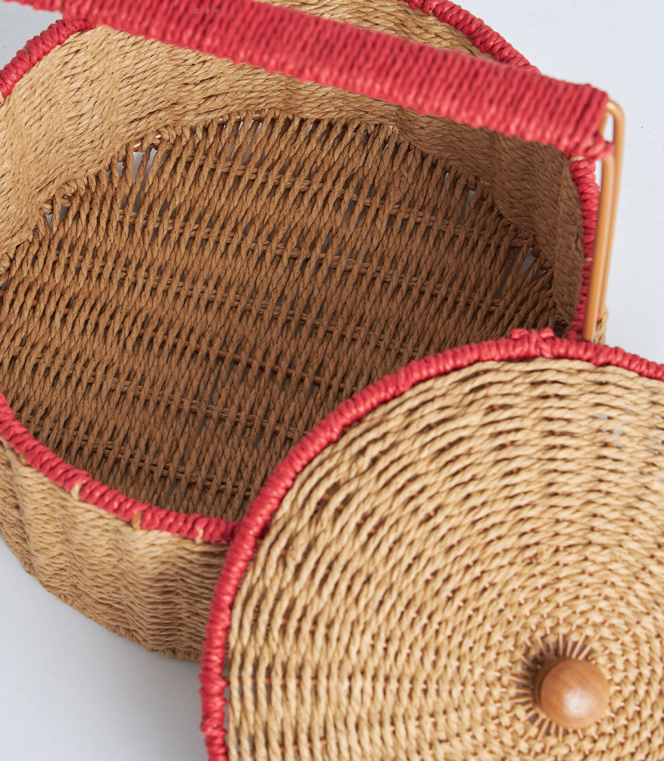 Natural woven basket with red trim handle and matching lid, artisan handcrafted gift storage