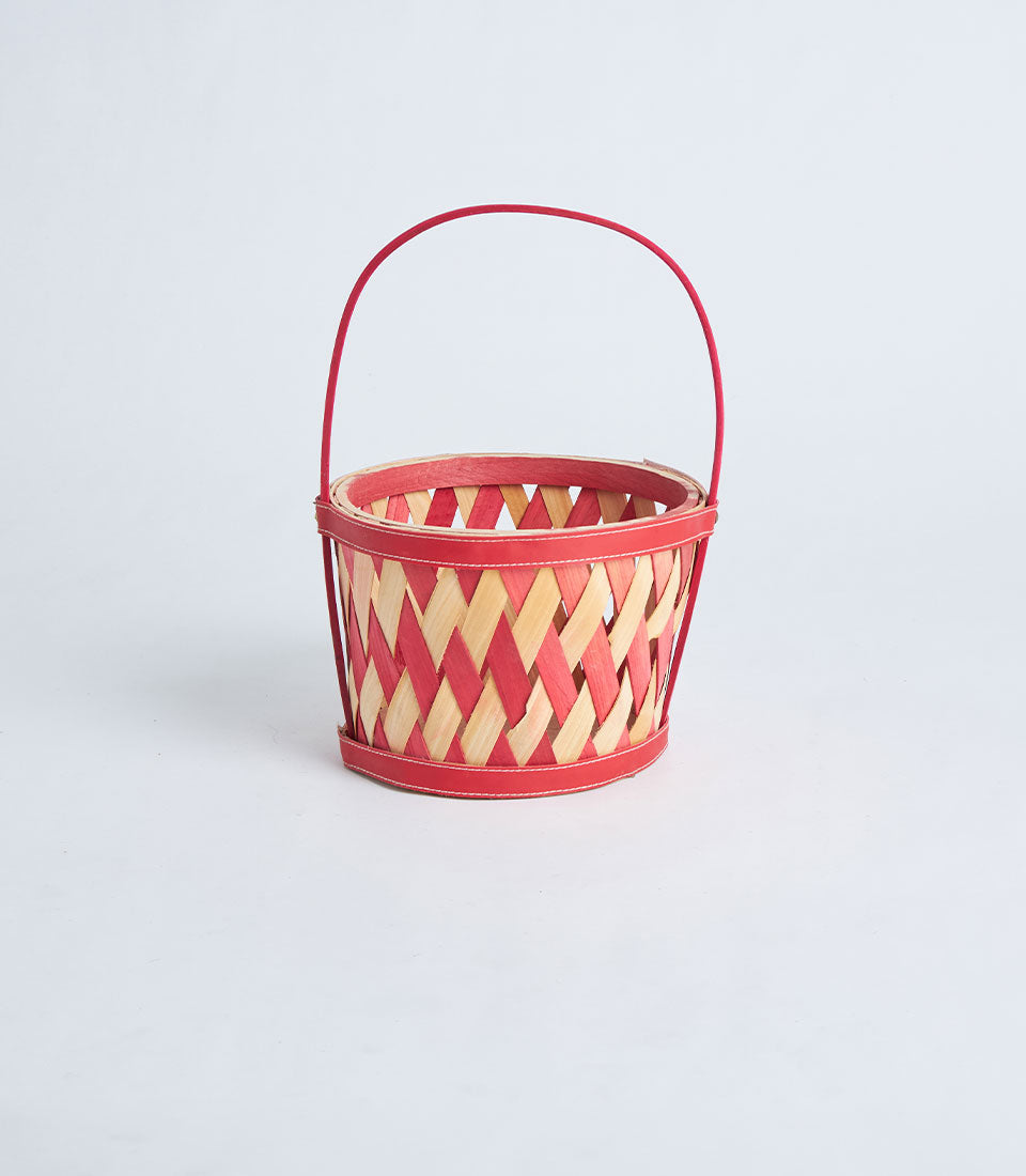 Two-tone bamboo round basket with red-stained wood, natural handle, and woven artisan craftsmanship