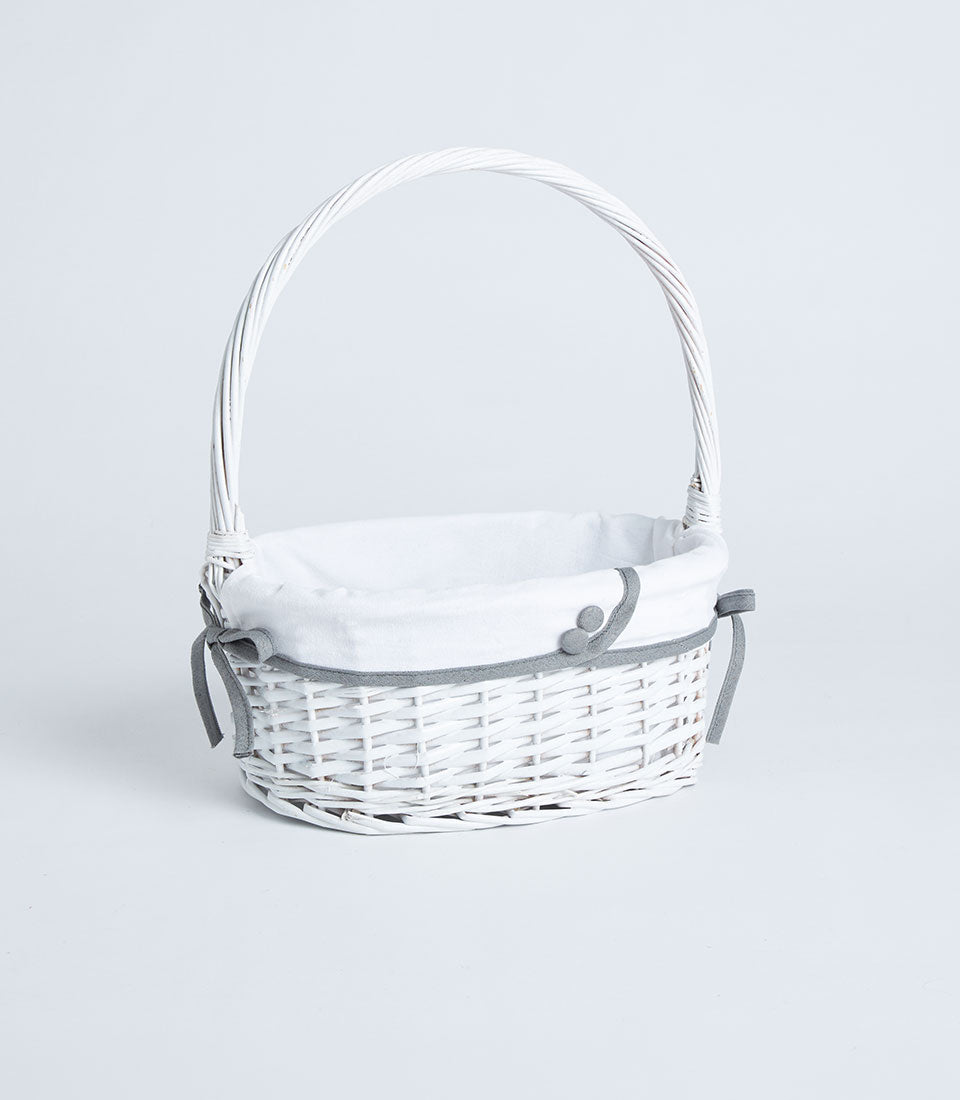 Handwoven white wicker basket with tall handle and grey ribbon trim detail