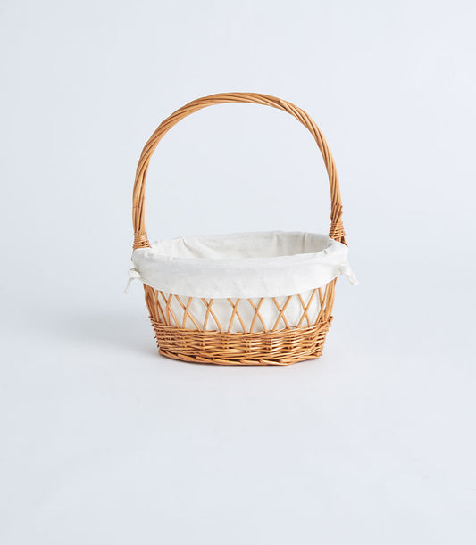 Light brown wicker oval basket with lattice weave, white fabric lining, and arched handle for gift hampers