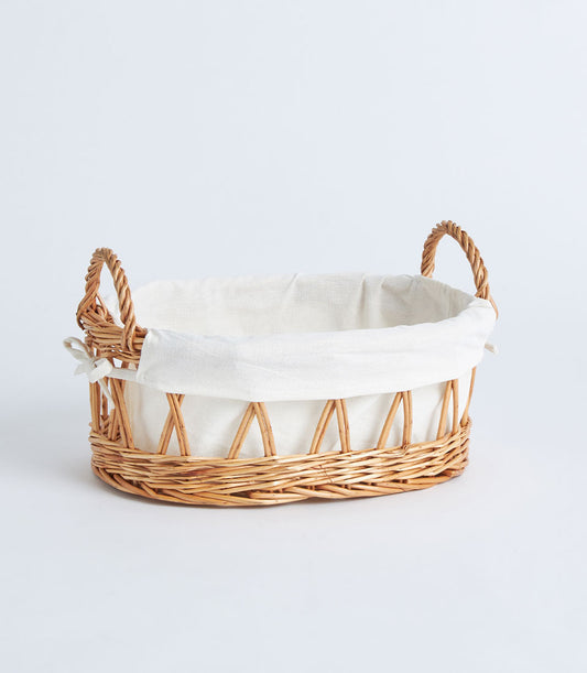Open weave wicker basket with cream linen lining and braided handles for luxury gift hampers