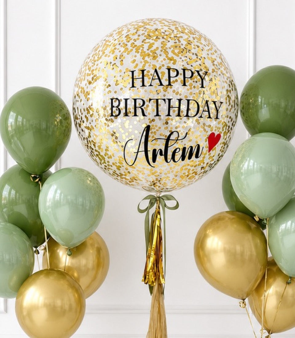 Large gold confetti balloon with "Happy Birthday Artem" text and heart, surrounded by sage green and gold metallic balloons with gold tassel.