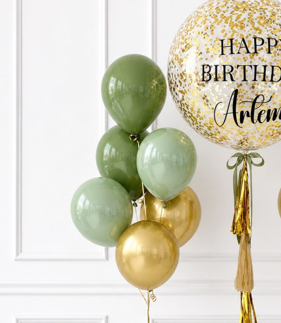Elegant birthday balloon arrangement featuring sage green and gold balloons with tassel decorations and personalized "Happy Birthday Arlene" confetti balloon.