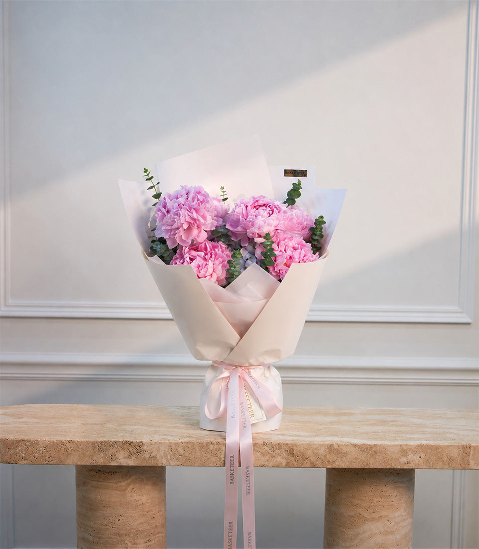Elegant soft pink peony bouquet with fresh eucalyptus, wrapped in luxurious cream paper and a