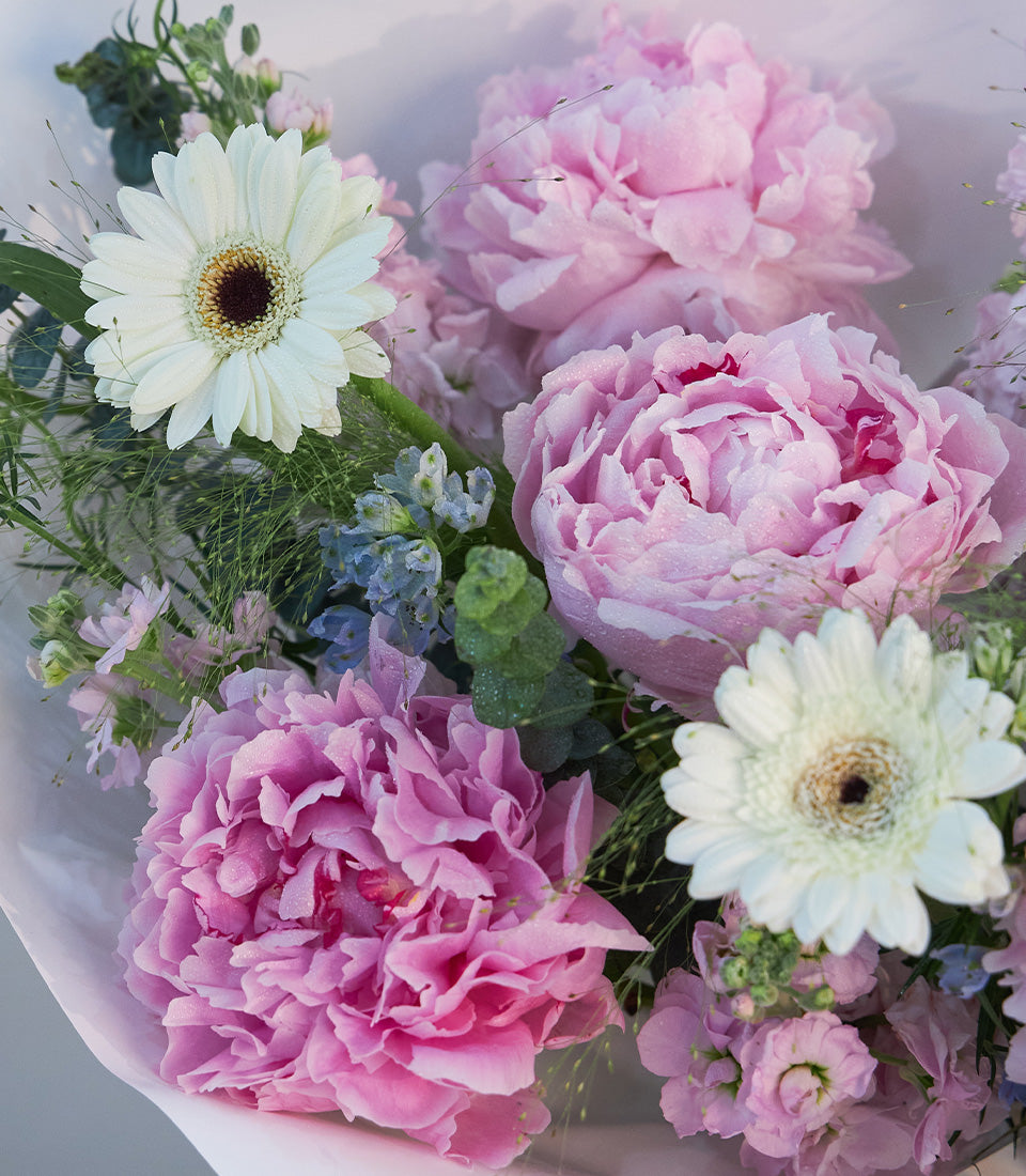 A luxurious Flowers by Basketeer bouquet featuring lush pastel pink peonies, delicate white
