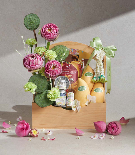 Songkran Delight wooden gift basket with pink lotus flowers, fresh mangoes, Thai snacks, and artisan preserves