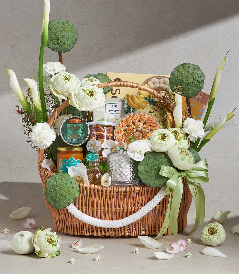 Shimmering white lotus and calla lily gift basket with gourmet preserves and artisan treats