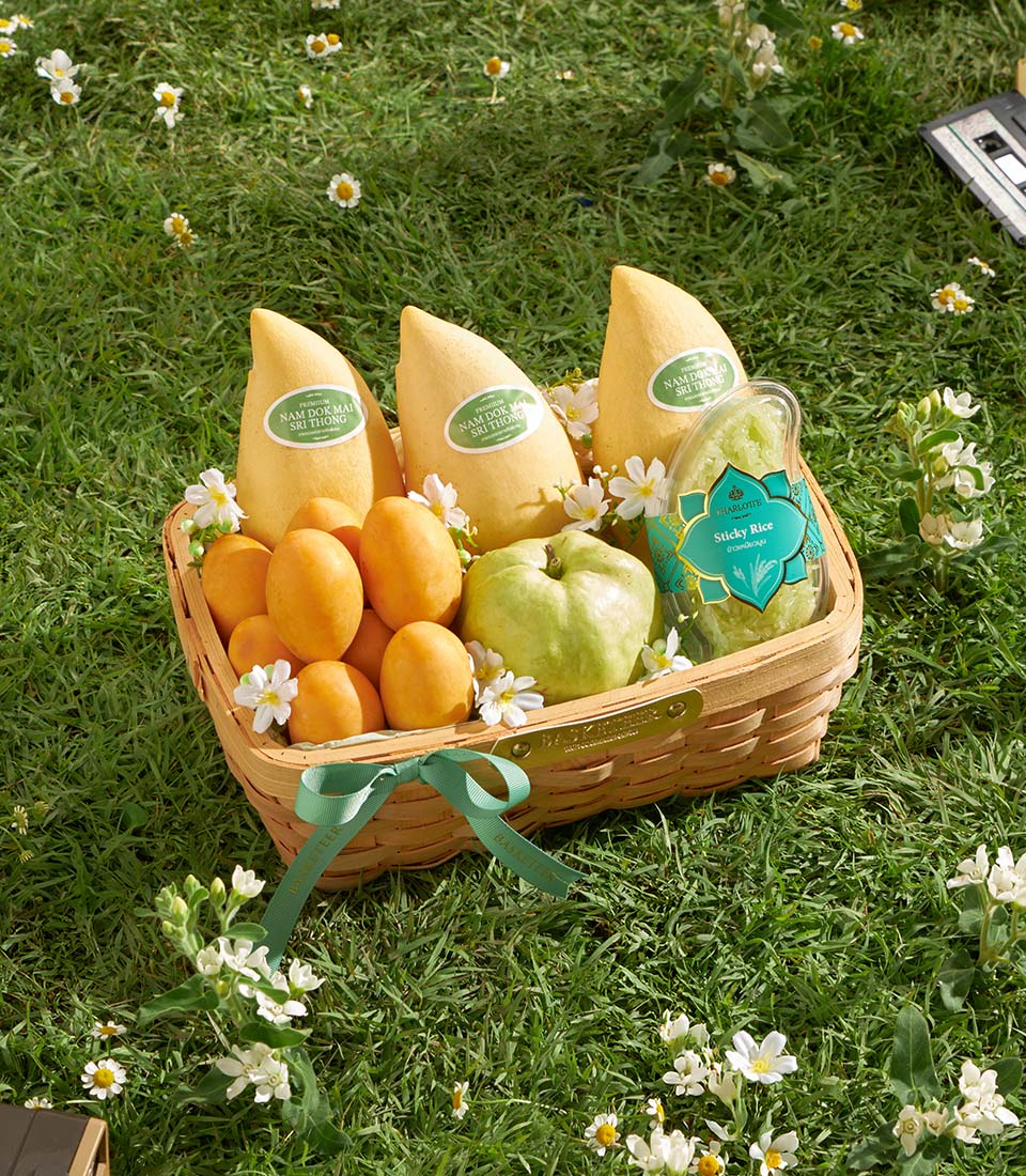 Premium mango, guava, and sticky rice gift basket with woven natural fibre and green satin ribbon