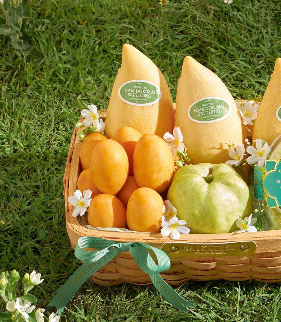 Premium mango and guava gift basket with sticky rice, woven with green ribbon bow