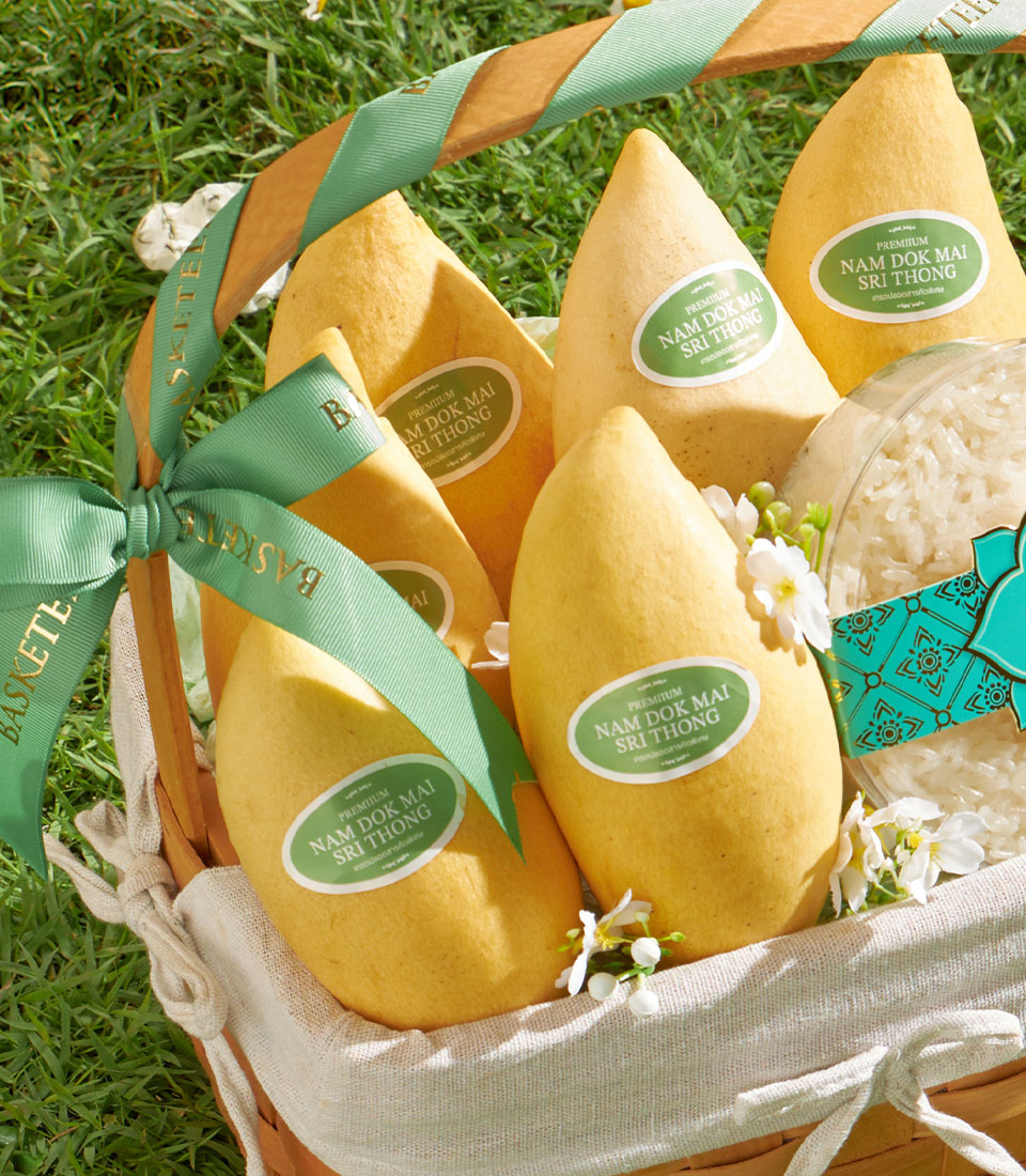 Premium Nam Dok Mai mango gift basket with sticky rice, woven wood hamper on green background